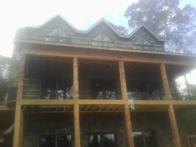Dormers and porch framing on a large log home under construction in Enterprise